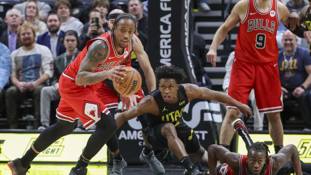 Chicago Bulls forward DeMar DeRozan (left) picks up a loos ball against the Utah Jazz during the fourth quarter at Delta Center.
